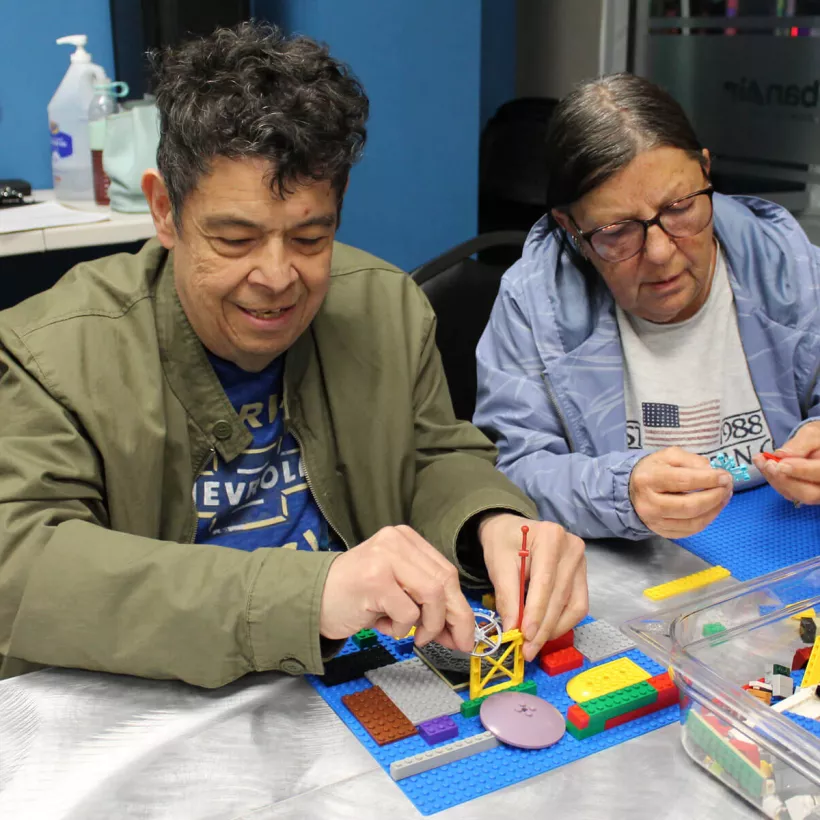 Two People Playing with Legos Together