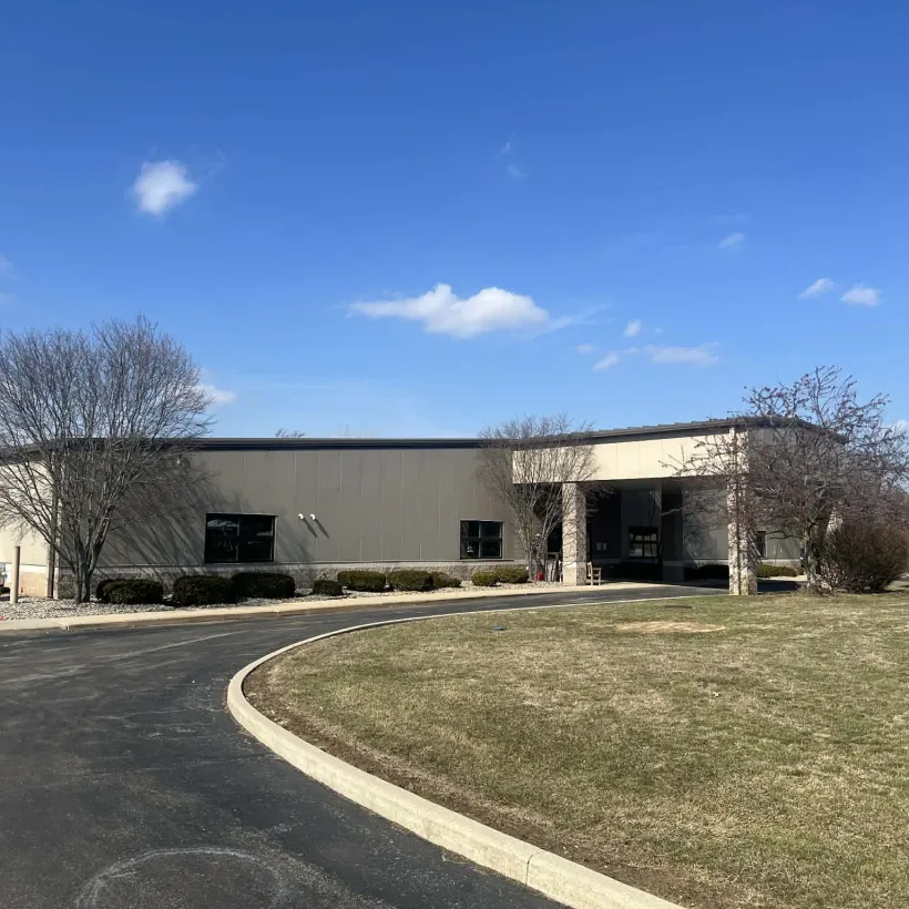 Building with blue skies and green grass